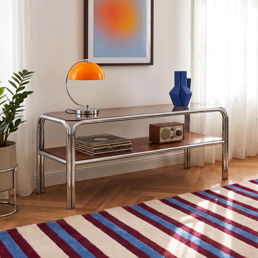 Mobile porta TV AMAYA da 120 cm con piano in vetro temperato marrone e ripiano in MDF, struttura in metallo cromato.